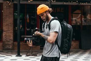 Man filming with a large video camera.